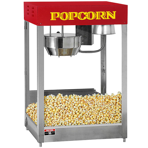 A Cretors popcorn popper with a red and white top.