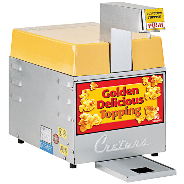 A Cretors countertop popcorn butter dispenser with a yellow top.