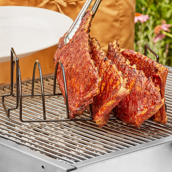 A rack of ribs on a grill using an Outset non-stick roast and rib rack.