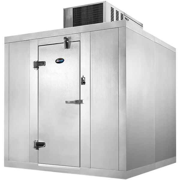 A large metal walk-in freezer with a white door.