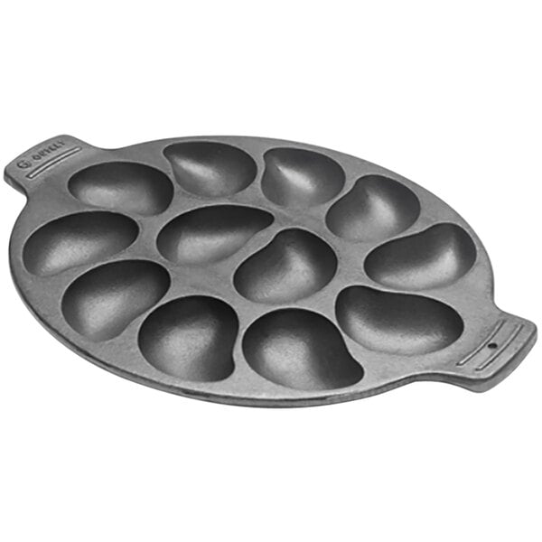 A round black cast iron pan with 12 compartments each holding an oyster.