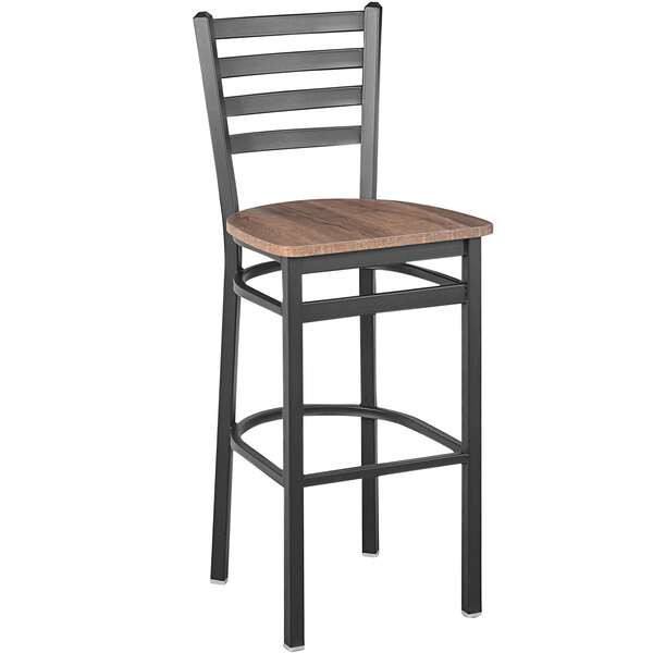 A BFM Seating black steel barstool with a wooden seat and ladder back.