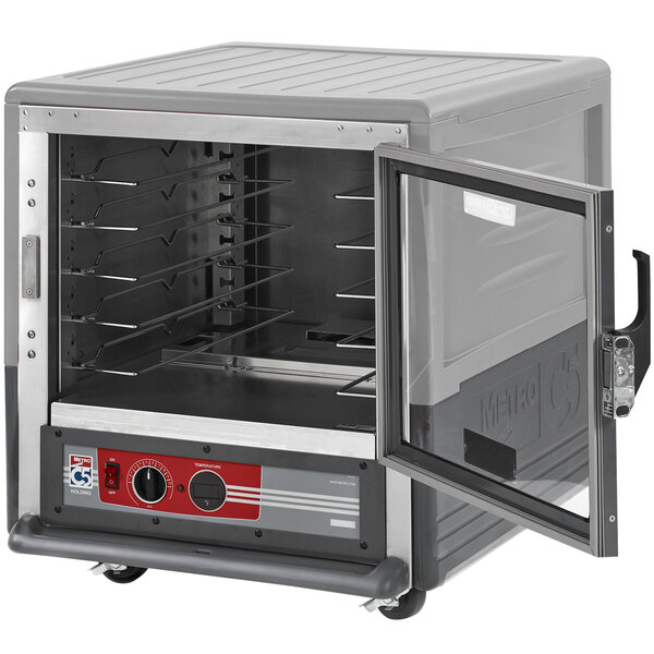 A gray Metro C5 heated holding cabinet with a clear door open and trays inside.