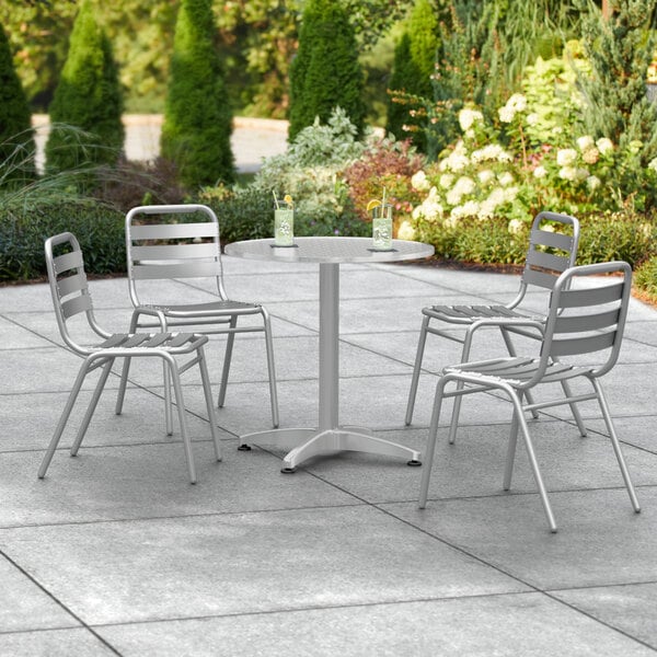 A Lancaster Table & Seating outdoor patio table with 4 chairs.