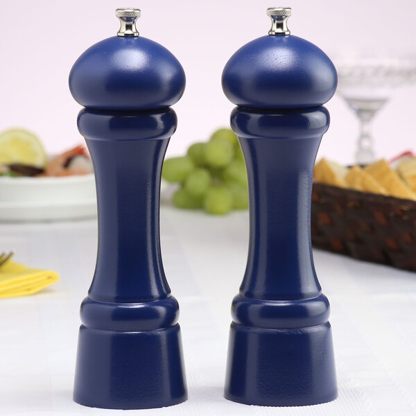 Two cobalt blue salt and pepper mills on a table.