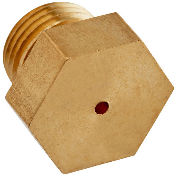 A gold hexagon shaped nut with a red dot.