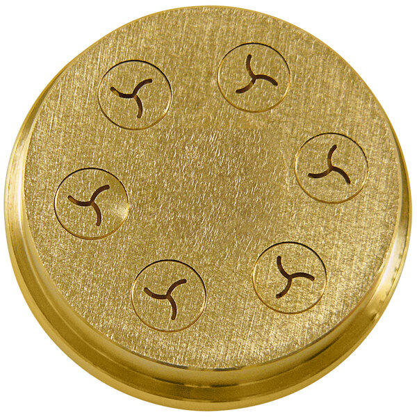 A gold-colored circular brass die with six circular holes.