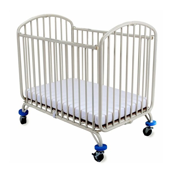 A white L.A. Baby folding metal arch crib with blue wheels.