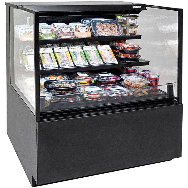 A Structural Concepts refrigerated self-service air curtain merchandiser with food inside.