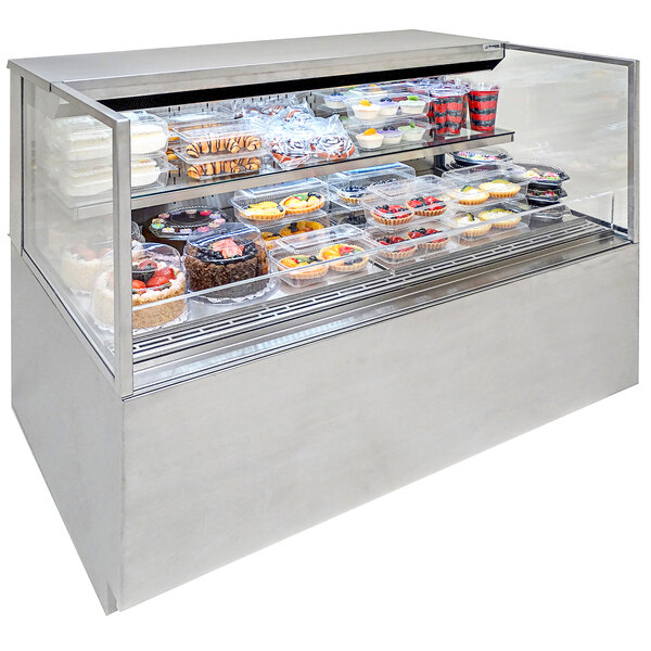 A Structural Concepts Reveal refrigerated self-service display case filled with cakes and pastries.