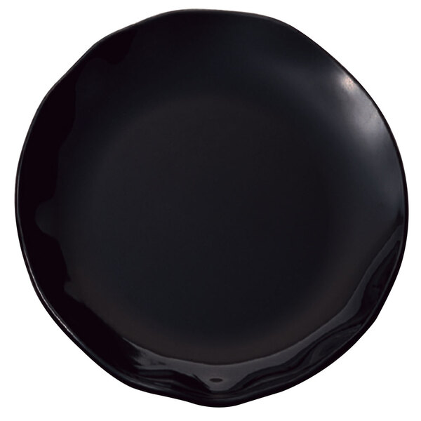 A black melamine platter with a rim and white dots on the rim.