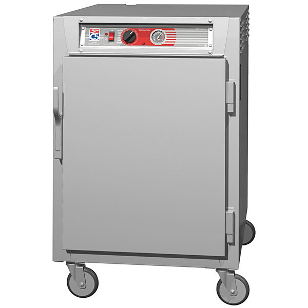 A grey rectangular Metro holding cabinet with a solid door and wheels.