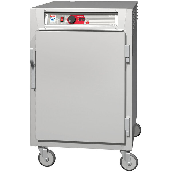 A white stainless steel Metro C5 holding cabinet with a door and wheels.