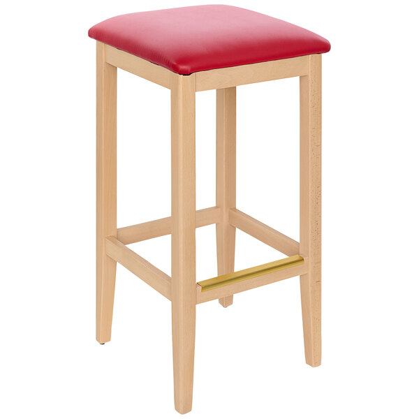 A BFM Seating Stockton wooden barstool with a red cushion.