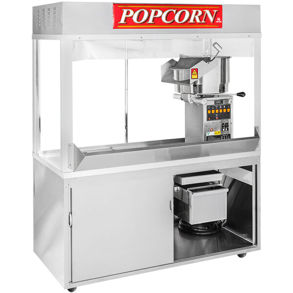A Cretors President popcorn popper with a glass door and a silver tray with a red sign.