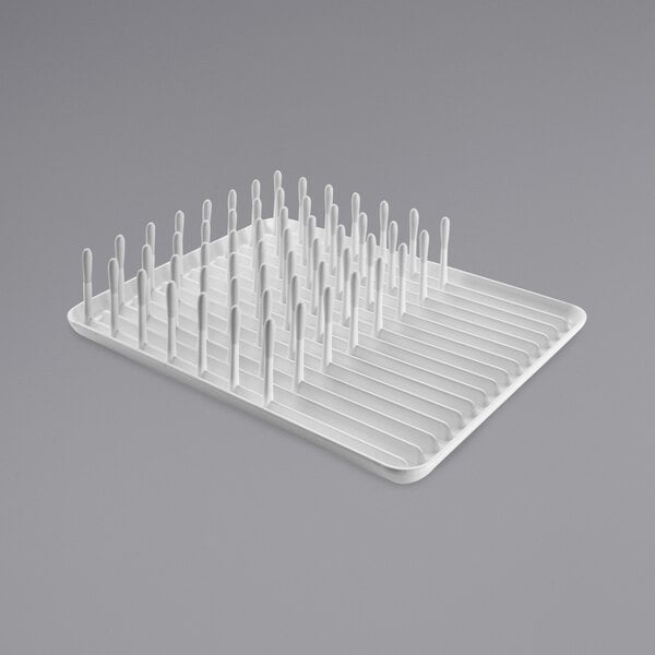 An OXO Good Grips white plastic dish rack with white utensils.