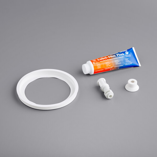 A white plastic pipe with a round white ring on it.