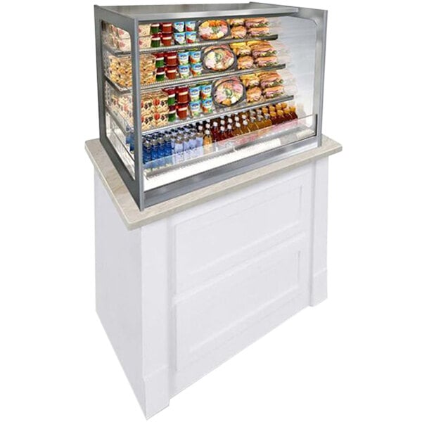 A Federal Industries Italian Glass Self-Serve Refrigerated Open Air Display Case with food on top.