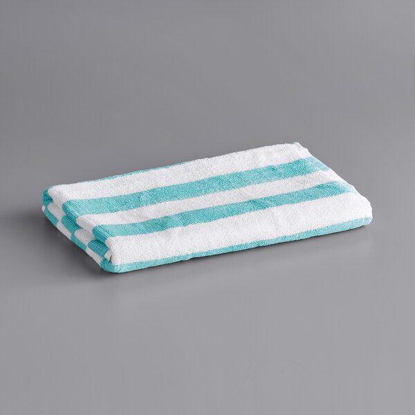 A white and turquoise striped Oxford Classic pool towel.