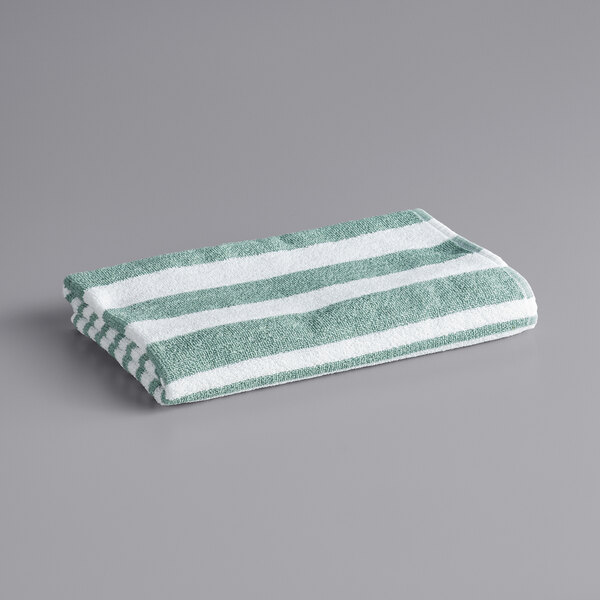 An Oxford green and white striped pool towel.
