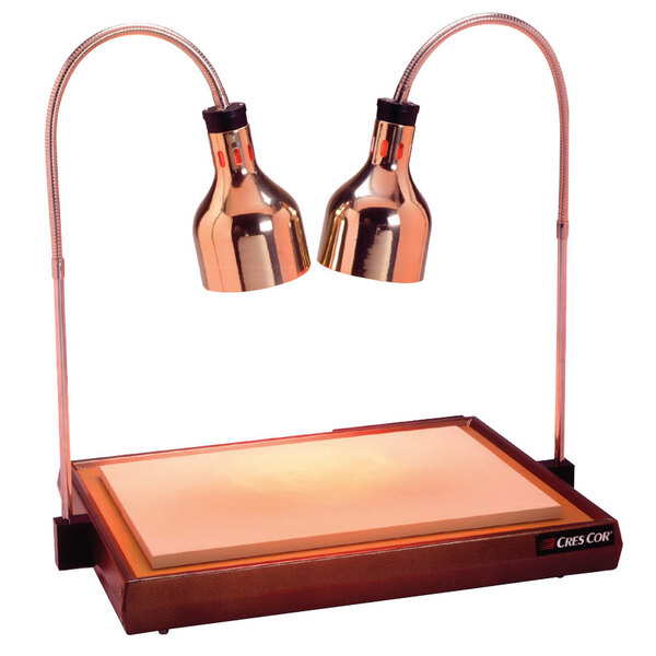 A Cres Cor carving station with two copper heat lamps.