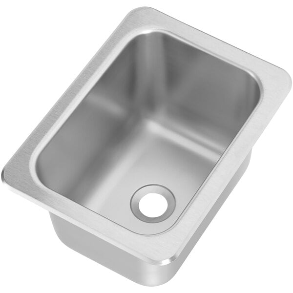 A Vollrath stainless steel sink with a drain.
