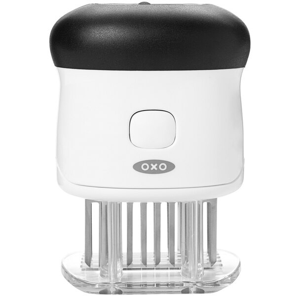 An OXO Good Grips meat tenderizer with a white handle and black blades.