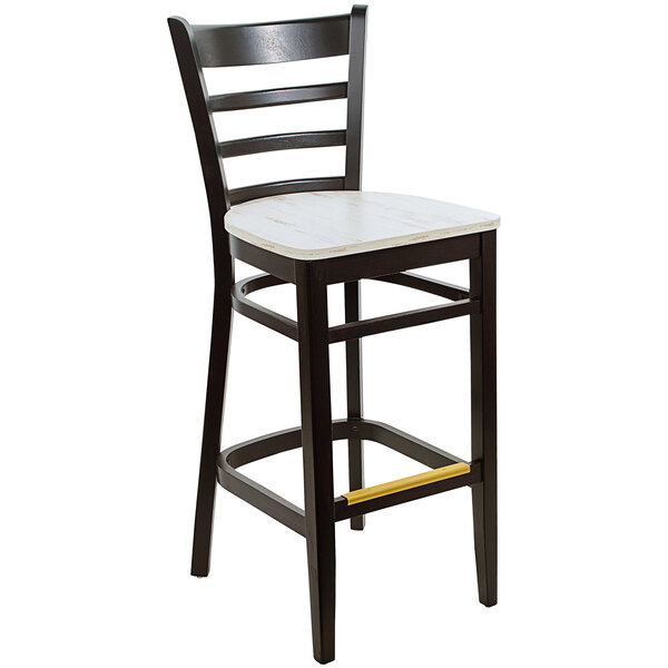 A BFM Seating black beechwood ladder back barstool with a yellow seat.
