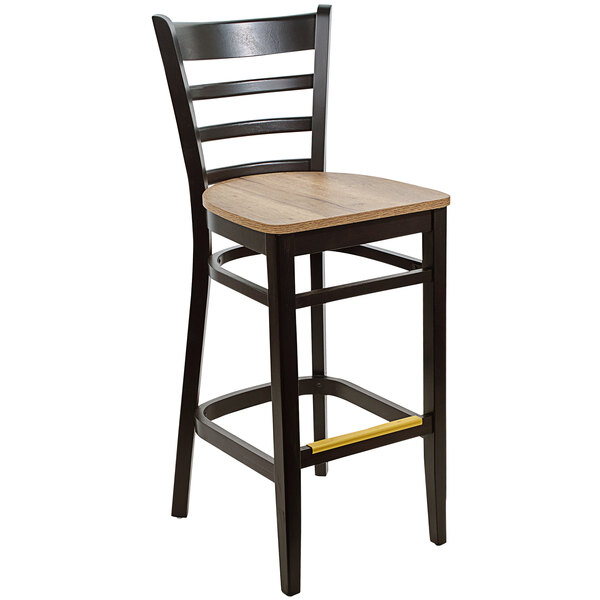 A BFM Seating black beechwood barstool with a wooden seat.