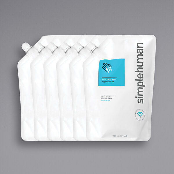 A group of white plastic bags with blue and white labels for simplehuman fragrance free foam hand soap refill.