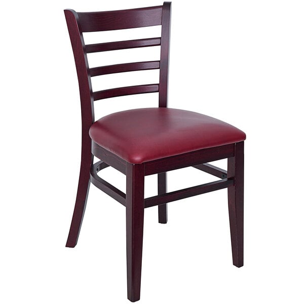 A BFM Seating wooden ladder back chair with a burgundy vinyl seat.