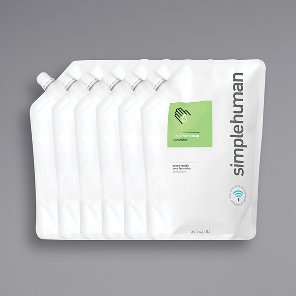 A group of simplehuman white plastic refill pouches with white labels.