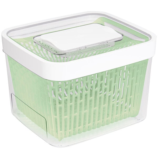 An OXO green plastic rectangular produce container with a lid.