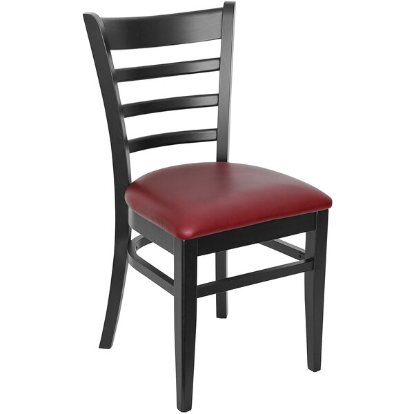 A BFM Seating black beechwood restaurant chair with a red vinyl seat.