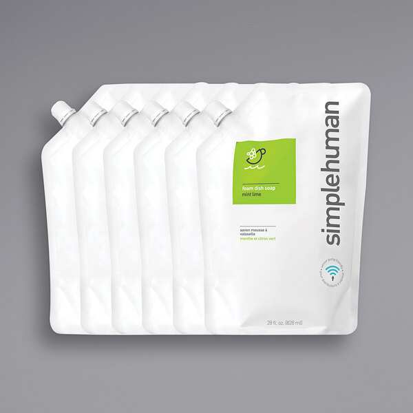 A group of white plastic pouches with mint green simplehuman labels and white caps.