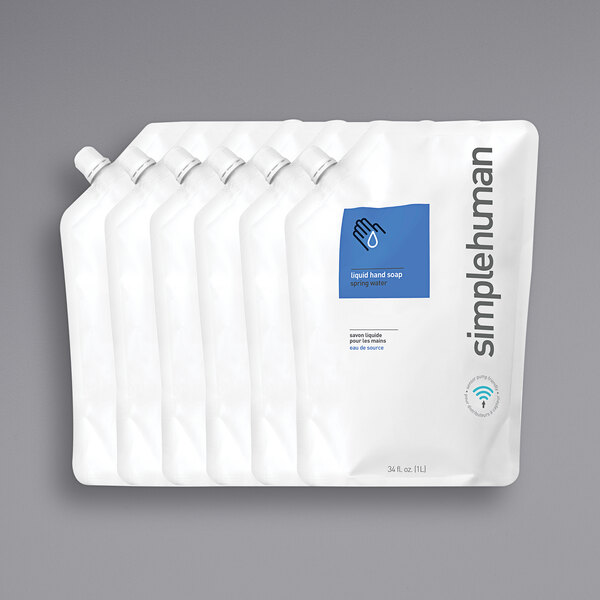 A group of white plastic pouches with blue labels of simplehuman Spring Water Scented Liquid Hand Soap.