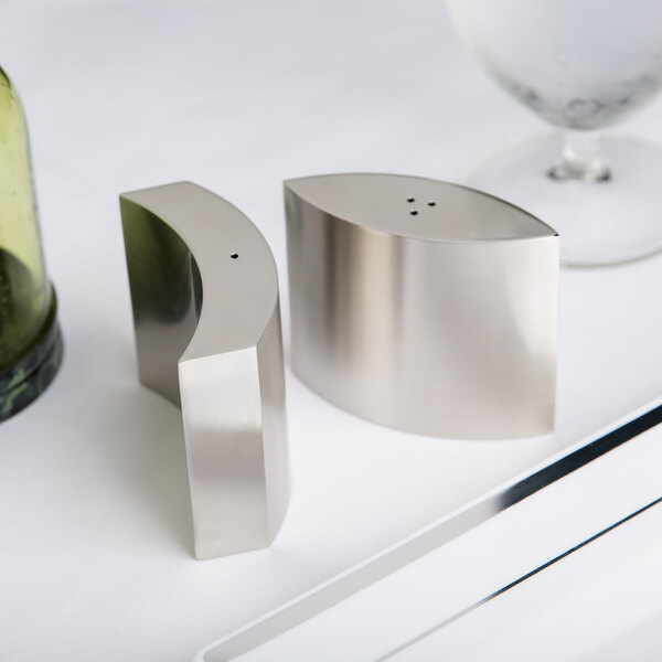 An American Metalcraft stainless steel salt and pepper shaker set on a table.