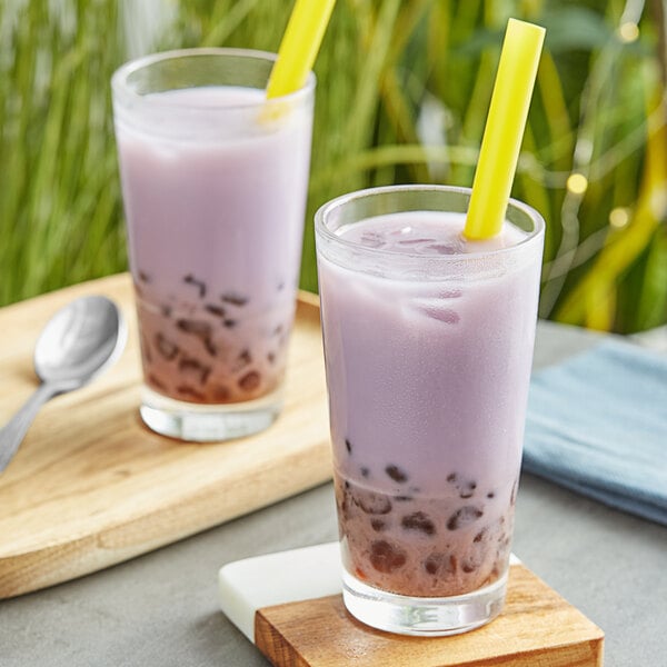 Two glasses of milk with purple Fanale Taro mixed in with straws.
