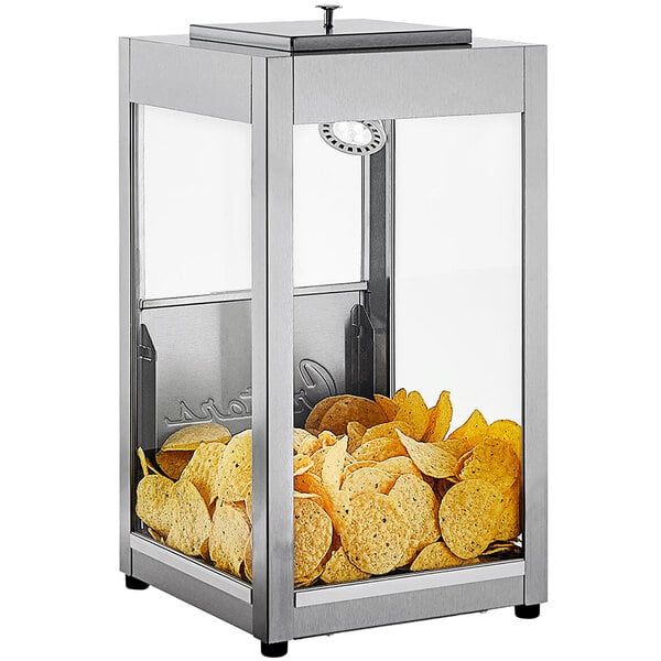 A silver Cretors countertop display case with chips inside.