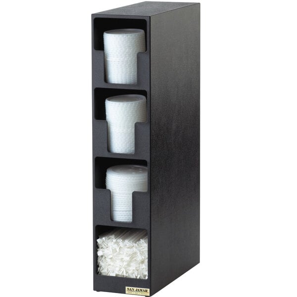 A black San Jamar countertop lid organizer with white plastic lids in three compartments.