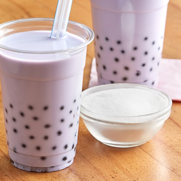A bowl of Balchem non-dairy creamer powder next to two cups of bubble tea.