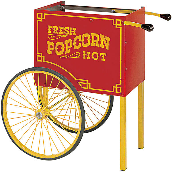 A red and yellow Cretors Goldrush popcorn cart with yellow lettering and wheels.