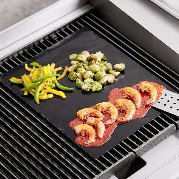 Mr. Bar-B-Q reusable grill mat with shrimp, vegetables, and other food on a grill.