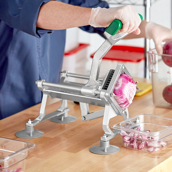 A person using a Garde vegetable dicer to cut a red onion.