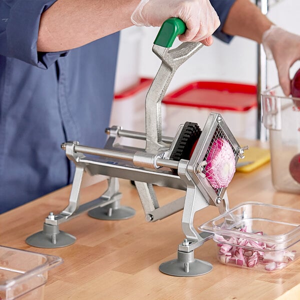 A person using a Garde vegetable dicer to chop onions.