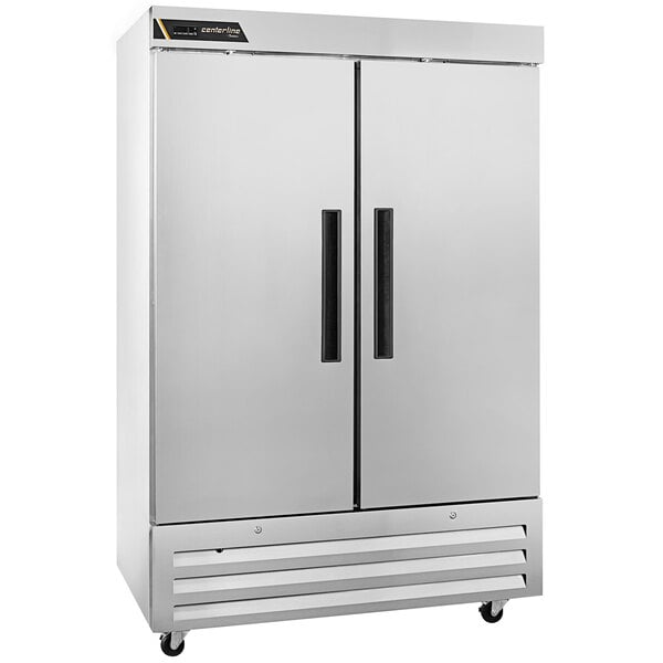 A large silver Traulsen reach-in refrigerator with two black half doors.