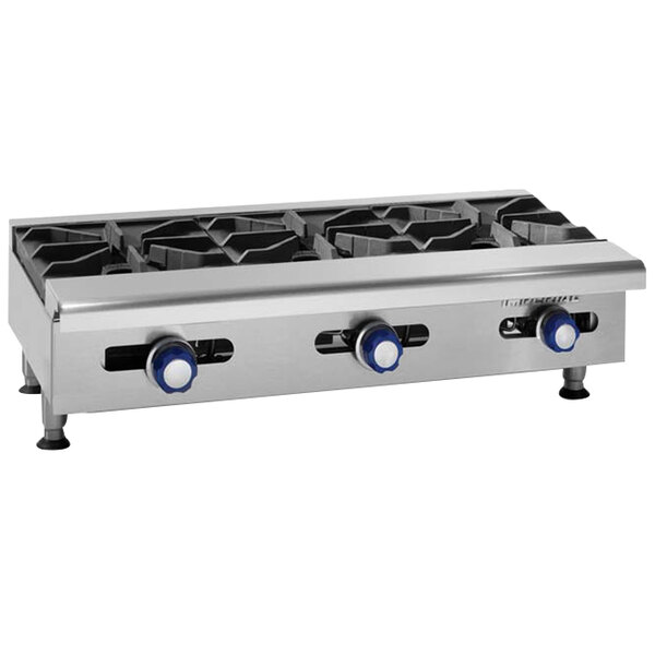 An Imperial stainless steel countertop with eight liquid propane burners.