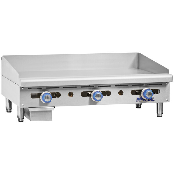 An Imperial Range stainless steel liquid propane countertop gas griddle with three burners.