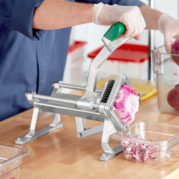 A person using a Garde table mount vegetable dicer to peel a red onion.