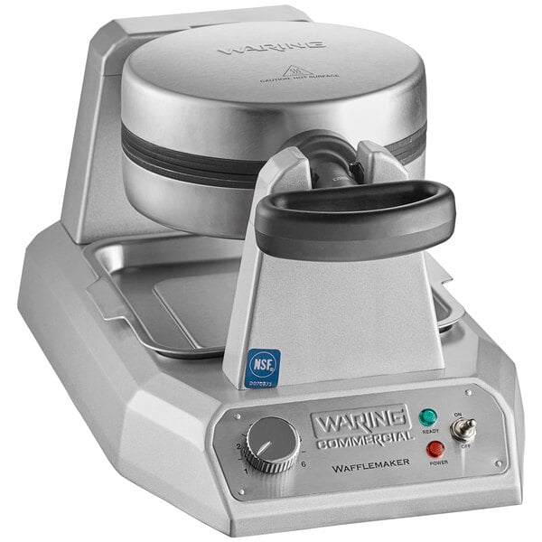 A Waring single classic waffle maker with a silver base and black round lid on a counter.